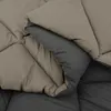 A close-up view of a folded duvet or comforter, showing the stitching and the two different colored sides. Náhľad obrázku produktu
