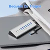 A silver USB hub with multiple ports is placed on a laptop, with a folded piece of clothing in the background. Produktbild-Vorschau