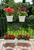 A balcony with potted flowers and a railing. Produktbild-Vorschau