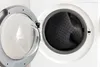 A close-up view of the inside of a washing machine with a rug inside. Produktbild-Vorschau