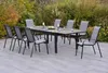 A patio set with a table and chairs in a garden setting. Produktbild-Vorschau