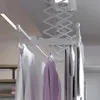 A ceiling-mounted electric clothes dryer with clothes hanging on it. Náhľad obrázku produktu