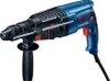 A blue and black Bosch rotary hammer drill is shown against a white background. Náhled obrázku produktu