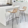 Two bar stools are placed in a modern kitchen setting, next to a white counter. Produktbild-Vorschau