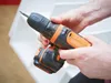 A person is holding a Black & Decker cordless drill. Podgląd zdjęcia produktu