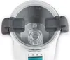 A close-up view of the top of a white and gray multi-cooker, showing the lid and interior. Produktbild-Vorschau