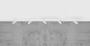 A white track light fixture with five adjustable spotlights is mounted on a white ceiling above a textured concrete wall. Náhľad obrázku produktu