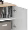 A close-up view of an open cabinet with books on a shelf and a storage box below. Náhled obrázku produktu