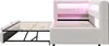 A white upholstered bed frame with an extended pull-out bed base, illuminated by pink LED lights in the headboard. Náhled obrázku produktu