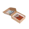 A kalimba instrument and its accessories are neatly arranged in an open cardboard box, with white foam padding protecting the contents. Produktbild-Vorschau