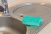 A close-up view of a kitchen sink with a sponge on the draining board. Anteprima dell’immagine prodotto