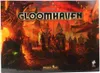 The image shows the box art for the board game Gloomhaven, depicting a fantasy town scene with characters. Produktbild-Vorschau