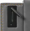 A close-up view of a gray upholstered headboard with brass nailhead trim, featuring a black integrated reading light and USB charging ports. Náhľad obrázku produktu