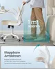 A person is standing next to an office chair, demonstrating its space-saving features. Produktbild-Vorschau