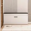 A shoe cabinet with a seat and storage, placed in an entryway with a door and a rug. Podgląd zdjęcia produktu