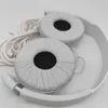 A close-up view of white headphones, showing the earcups and part of the headband and cable. Podgląd zdjęcia produktu