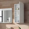 A white bathroom cabinet with shelves is shown next to a mirror on a wood-paneled wall. Produktbild-Vorschau