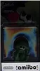 A Splatoon amiibo figure in its packaging, with a colorful, abstract background. Produktbild-Vorschau