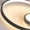 A close-up view of a modern, curved LED ceiling light. Produktbild-Vorschau