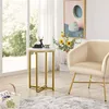 A side table with decorative items next to a chair in a well-lit room. Produktbild-Vorschau