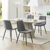 A dining set with four chairs around a table in a bright, modern kitchen. Voir les images du produit