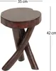 A wooden stool with a round top and crossed legs, shown against a white background with dimensions indicated. Náhled obrázku produktu