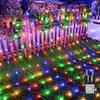 Christmas lights decorating a wooden fence and lawn in front of a house. Produktbild-Vorschau