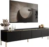 A modern black TV cabinet with gold accents and legs, topped with decorative items and a large flat-screen television displaying abstract art. Produktbild-Vorschau