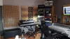 A recording studio with acoustic wall panels, keyboards, and audio equipment. Náhľad obrázku produktu