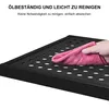 A hand is wiping a black perforated shelf with a pink cloth, with German text above indicating it is oil-resistant and easy to clean. Produktbild-Vorschau