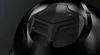 A close-up, detailed view of a black object with a geometric, textured design. Voir les images du produit