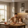 A father and daughter are having breakfast at a wooden table in a bright kitchen. Náhled obrázku produktu