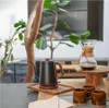 A coffee brewing setup with a kettle and a pour-over coffee maker. Anteprima dell’immagine prodotto