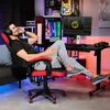 A man is relaxing in a gaming chair in a room with a computer setup. Produktbild-Vorschau