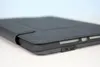 Close-up side view of a dark gray tablet case with a USB-C port visible. Produktbild-Vorschau