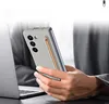 A person is holding a smartphone with a stylus in a setting with a laptop. Produktbild-Vorschau