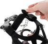 A close-up of a hand adjusting a strap on a pair of ice cleats. Podgląd zdjęcia produktu