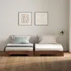 Two beds side-by-side in a room with artwork on the wall. Produktbild-Vorschau