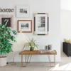A living room scene with a floor lamp, plants, and framed pictures on the wall. Anteprima dell’immagine prodotto