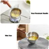 A collage showing a small metal pot with a wooden handle being used on a stove and on a heating element. Voir les images du produit