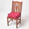 A wooden chair with a red cushion on it, set against a white background. Náhled obrázku produktu