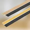 Two strips of brush seal for doors, one with a wood-grain finish and the other with yellow adhesive tape. Produktbild-Vorschau