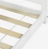 A close-up view of the white wooden frame and slatted base of a bed. Náhľad obrázku produktu