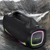 A black portable speaker with colorful LED lights is placed on a rocky, mountainous terrain. Produktbild-Vorschau