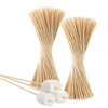 Bundles of bamboo stakes and three marshmallows on skewers. Produktbild-Vorschau