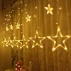 A string of star-shaped lights hanging against a sheer curtain. Produktbild-Vorschau