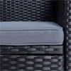A close-up view of a black polyrattan outdoor furniture set with a gray cushion. Produktbild-Vorschau