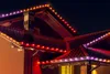 A house roof decorated with colorful LED lights at night. Podgląd zdjęcia produktu