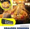 A family is enjoying a meal outdoors at night, illuminated by string lights and a patio heater. Produktbild-Vorschau