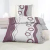A neatly made bed with a duvet and pillow featuring a geometric pattern. Produktbild-Vorschau